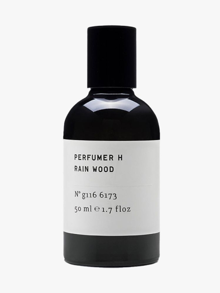 Black bottle of Perfumer H Rain Wood Eau de Parfum with white label and black cap on light gray background 
