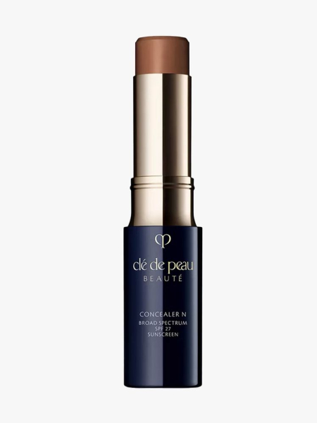 Navy blue Clé de Peau Beauté Concealer on light gray background